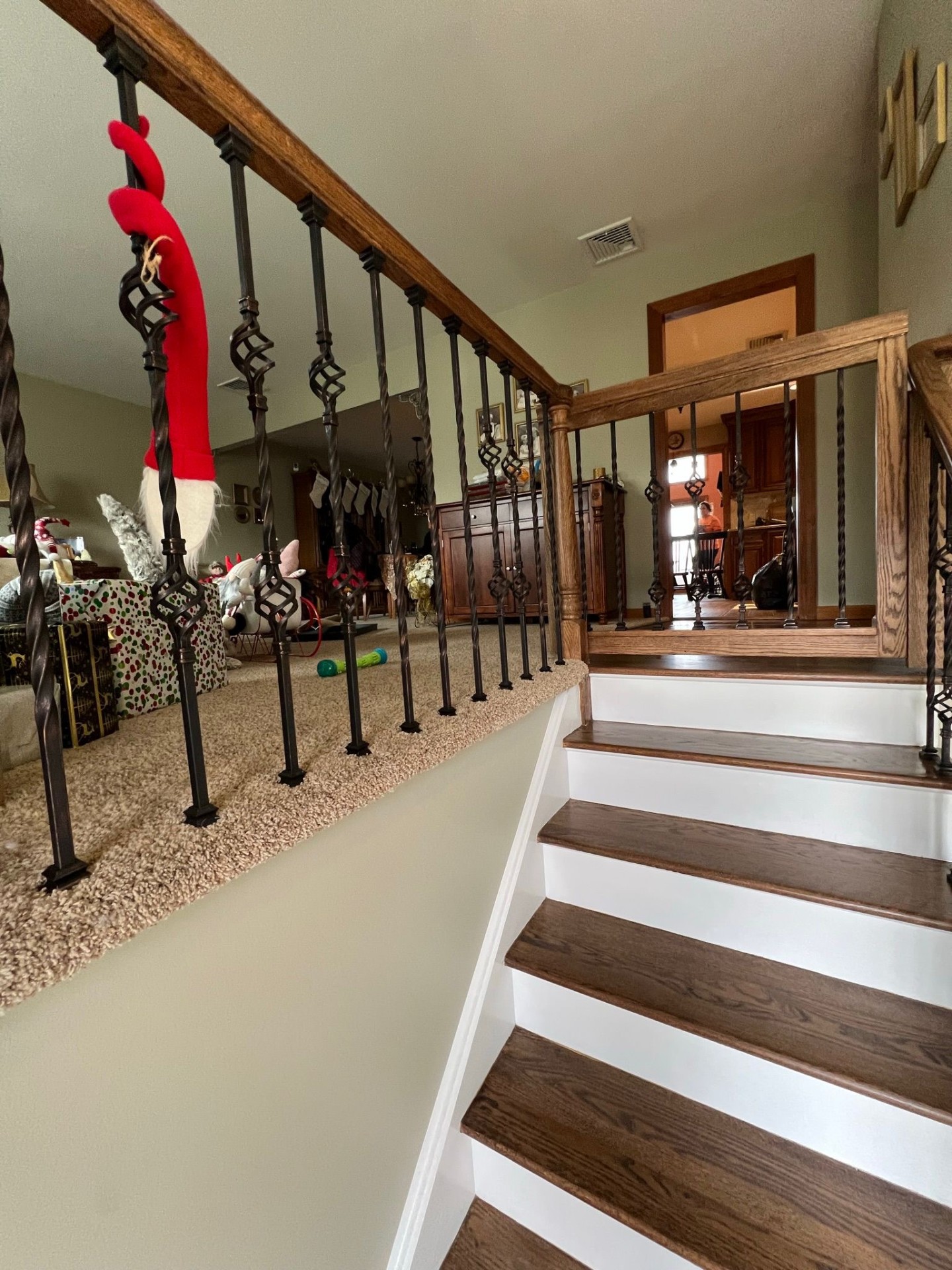 Finished staircase with dark oak treads and wrought iron balusters