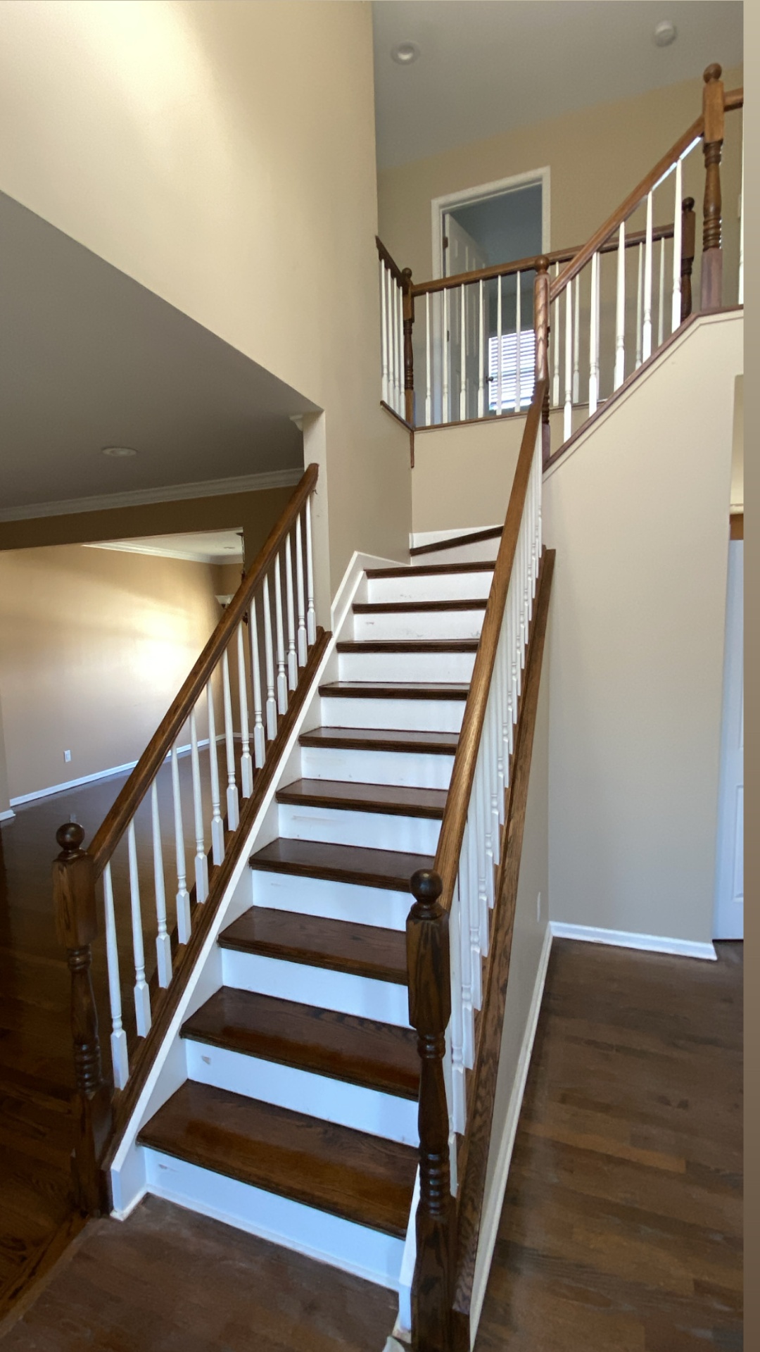 Refinished oak staircase with white balusters and dark handrail