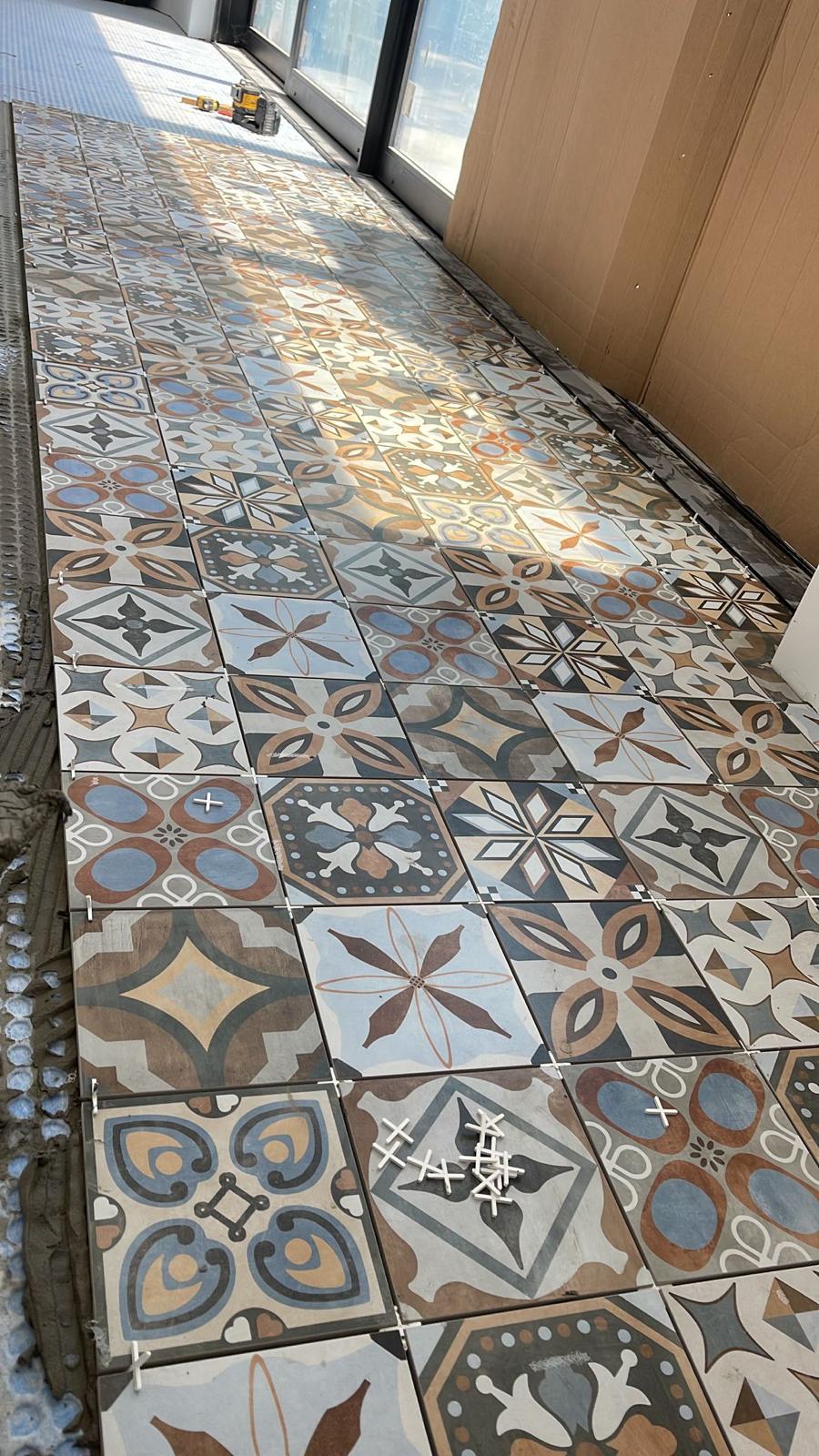 Colorful patterned encaustic cement tile floor installation