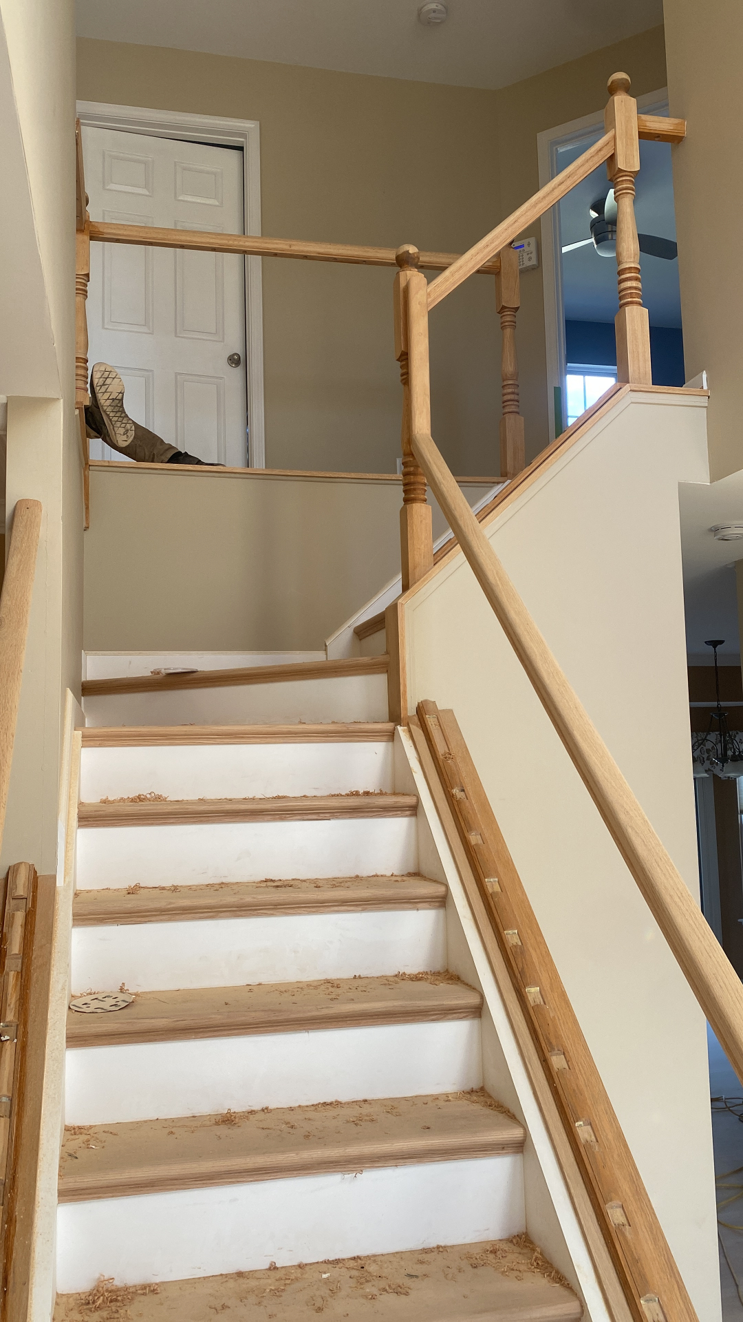 Staircase installation in progress with new oak treads and railings