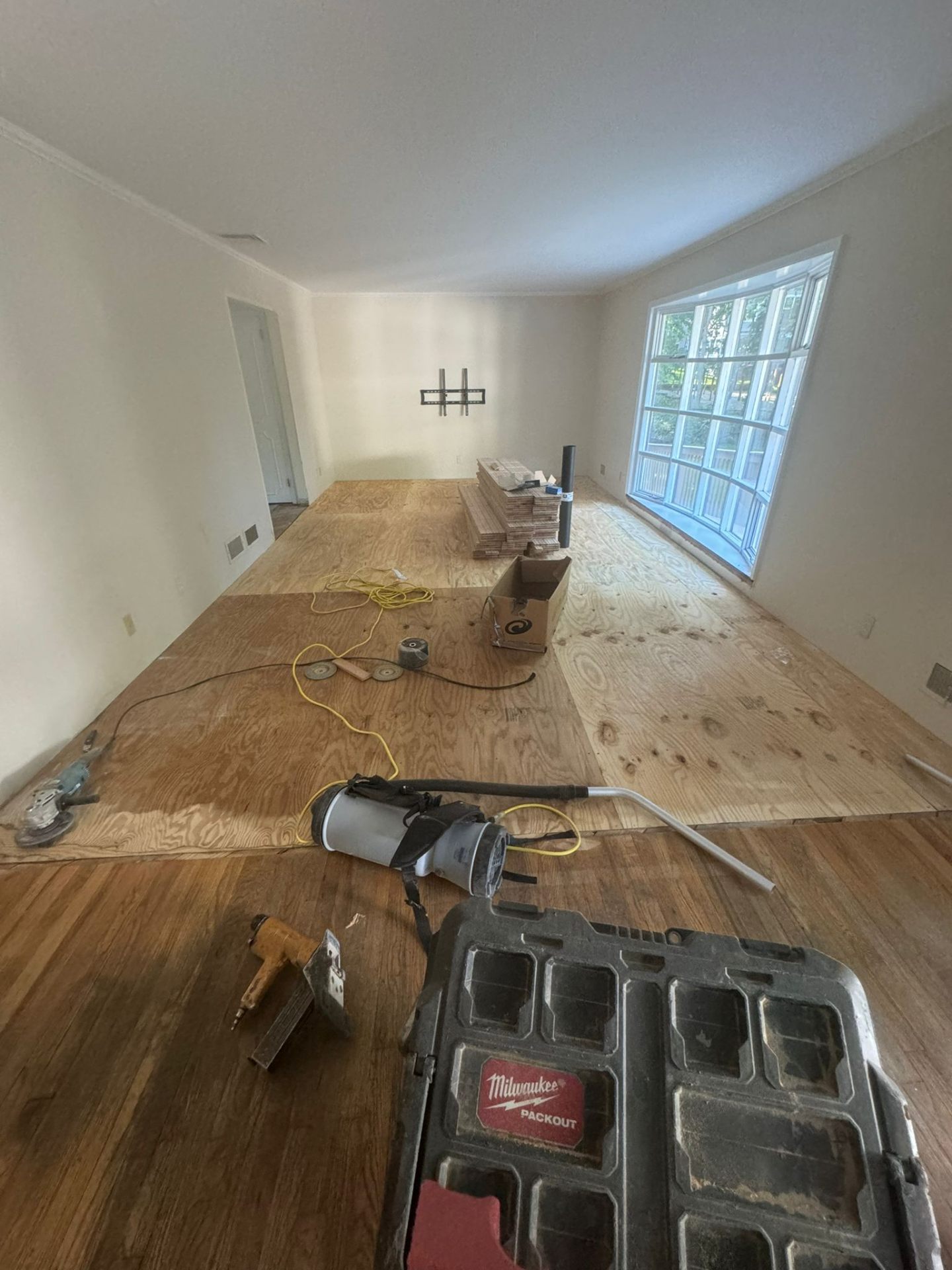 Living room hardwood installation underway