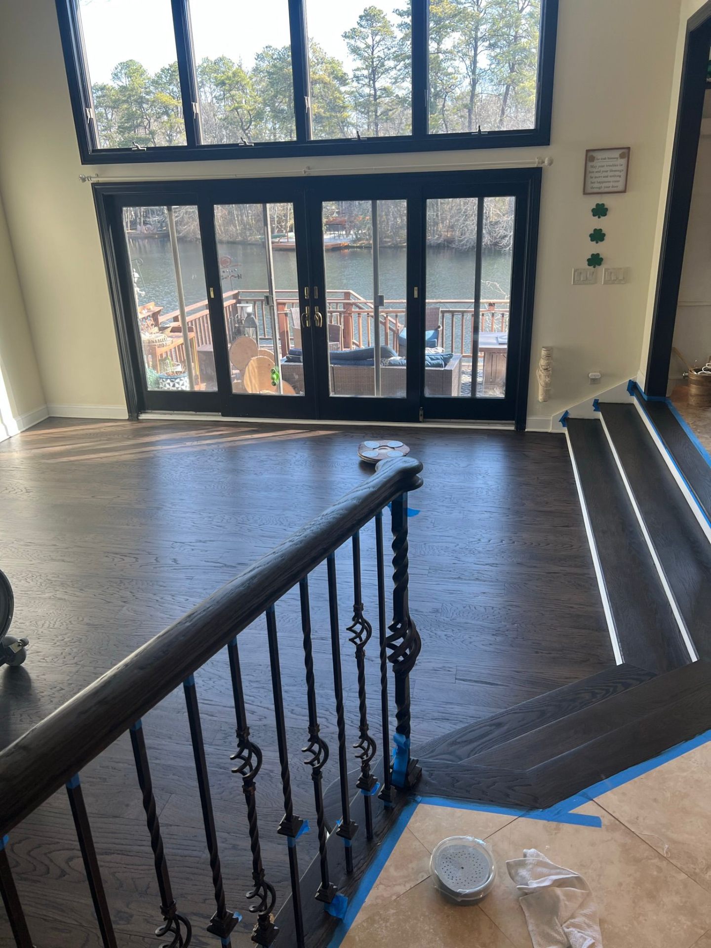 Refinished dark hardwood floor and staircase with lakeside view